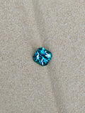 Blue gemstone on a beige fabric background