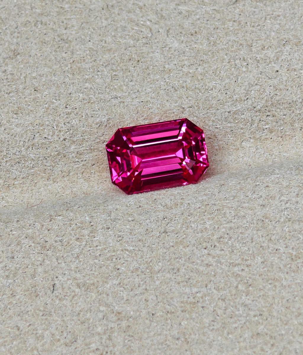 Pink gemstone on a beige background